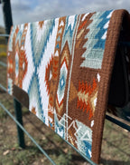 Em Custom Ranch Pads Best On Earth, brown, sand, buckskin, rust, white, denim blue, niagara blue & sky blue tones, western ranch pad in stock lifestyle